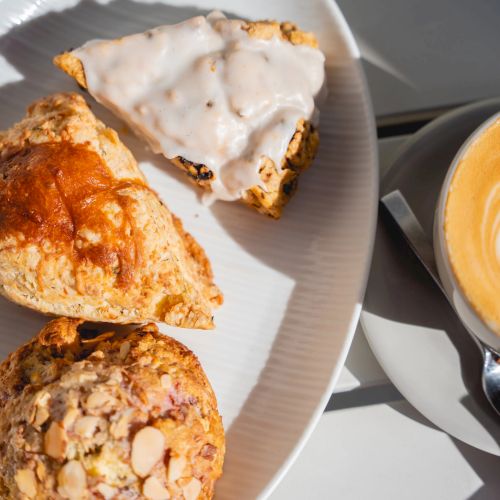 Cookies and a glass of milk, with crumbs on a plate.